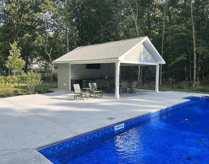 Custom-built backyard pool house with covered patio